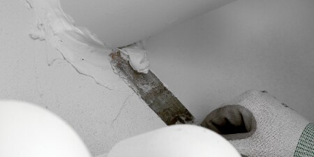 Worker sealing a joint around a pipe
