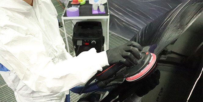 Image showing a man using pair premium Abrasives with premium tools on a car to achieve excellent results
