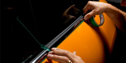 close up of knifeless tape on a car window install
