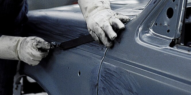 Operator repairing automotive panel
