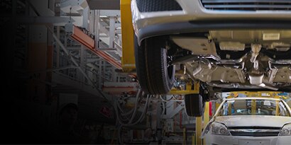 The undercarriage of a vehicle on an automotive assembly line.
