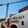 Fall protection demonstration truck on worksite with crane in background