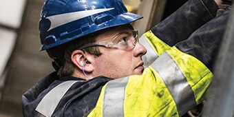worker wearing corded earplugs
