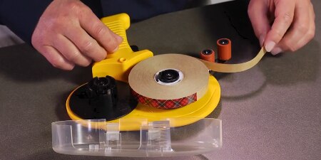 Technical service engineer demonstrating how to load the Scotch® ATG 700 Adhesive Applicator
