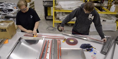 Image of two people applying VHB tape
