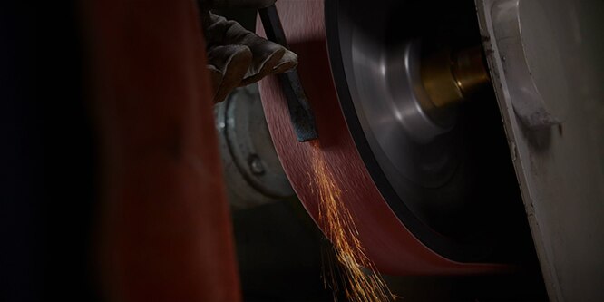 Image showing metalworking grinding & refining for a #8 finish on stainless steel process in action
