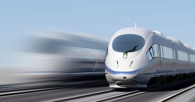 Photo of a grey train moving at high speeds.
