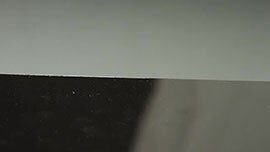 Video still showing a metal substrate before abrasion