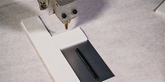Image of a part with 3M™ VHB Extrudable Tape applied
