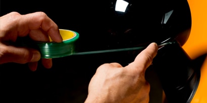 knifeless tape leaving a clean line on an auto wrap film install
