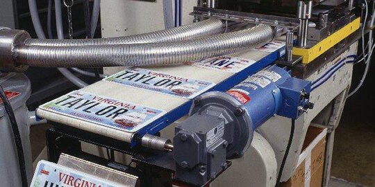 License plates are printed on a large-scale printer.
