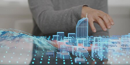 Person looking at a hologram of a city.
