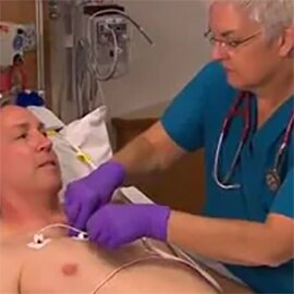 Nurse with patient adjusting patient monitoring leadwires and cable