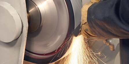 worker using grinding wheel
