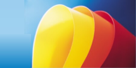 Curved samples of yellow, orange, and red solid color films on blue background
