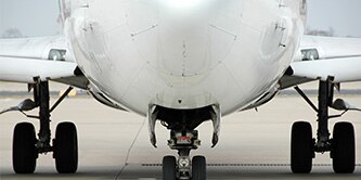 The bottom half of an airplane on a runway.