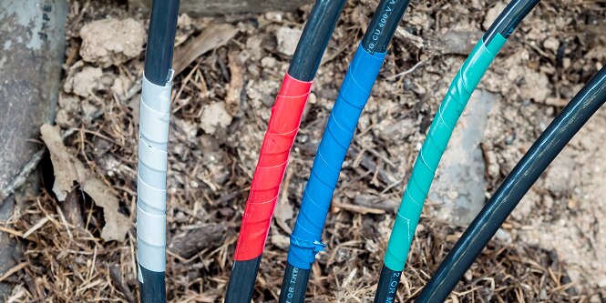multiple electrical cables with different color coded electrical tape
