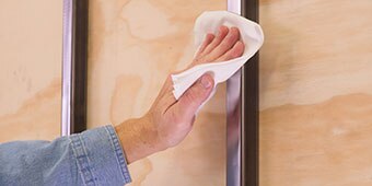Image of someone doing a quick solvent wipe on a metal post
