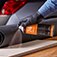 Learn about assembly applications. Image of spray adhesive being applied to a wood surface.