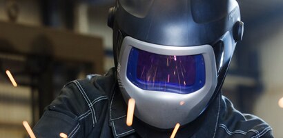 welder in a full face mask and helmet
