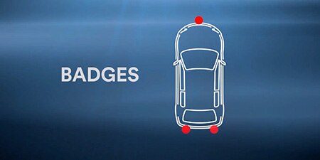 The outline of a vehicle with badges highlighted
