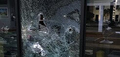Shattered window shards being held together with protective window film