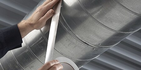 image of hands applying high temp tape solution

