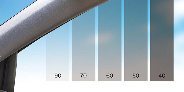 a graphic of shades of grey lined up on a car window to represent window tint film options.
