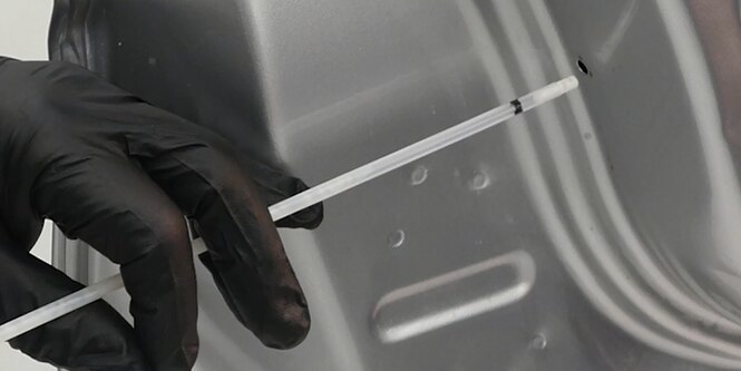 Technician applying 3M Cavity Wax
