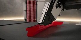 The RoboTape™ System for 3M™ Tape applies adhesive to a product
