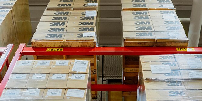 A vertical-looking shot of 3M boxes and pallets housed in a warehouse
