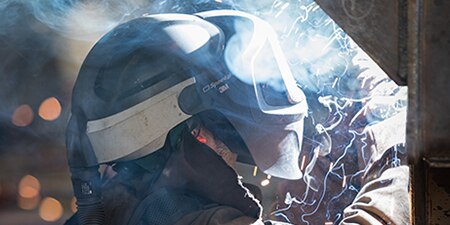 Individual using a 3M™ Adflo™ Powered Air Purifying Respirator (PAPR) System
