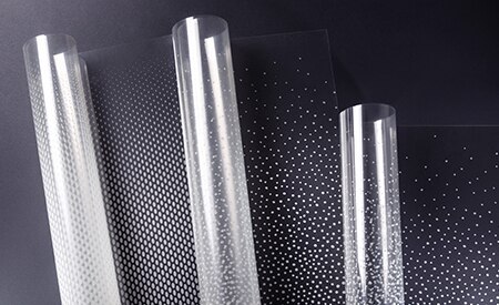 Three unspooling rolls of 3M FASARA glass finishes with dot gradation patterns
