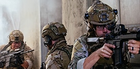 three men in military garb
