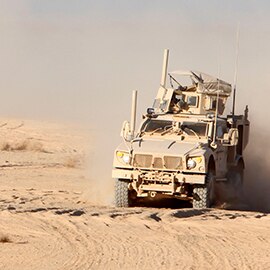 Military land vehicle in harsh desert conditions
