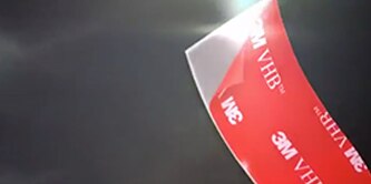 Video thumbnail for the 3M™ VHB™ Tapes Drop Shock Resistance Video, showing a close-up of the tape being tested for its ability to withstand impact and protect devices.

