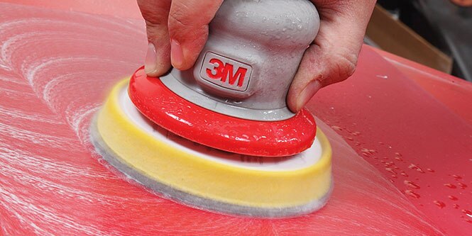 image of a 3M tool being used on a red vehicle
