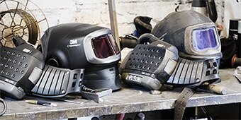 work bench with two welding helmets
