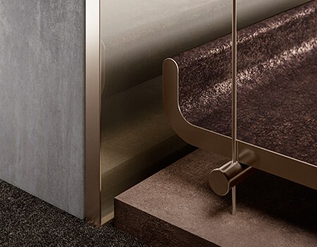 Close up of bench and wall finished with various metallic 3M surface finishes.

