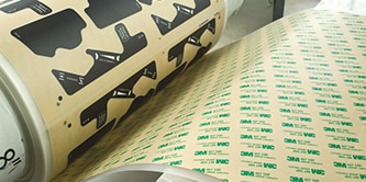 Image of a die-cut roll of tape being wound on a roll
