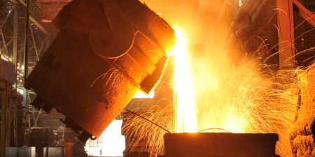 molten metal being poured in metal processing plant
