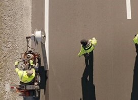 3M™ Stamark™ Removable Black Tape 715IR being rolled onto pavement