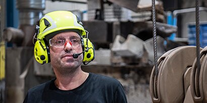 worker wearing protective communication hearing protection
