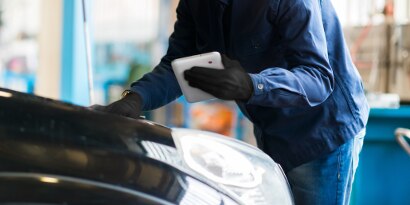 image of technician inspecting vehicle
