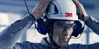 Man speaking into 3M Protective Communications headset
