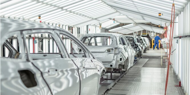 Painted cars on automotive assembly line
