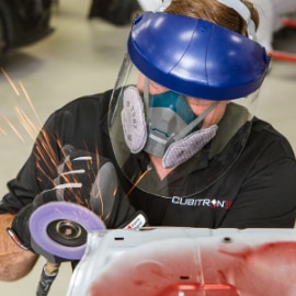 worker grinding wearing a respirator