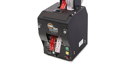 Gray electronic dispenser with equal lengths of red and white tape ready for removal and application
