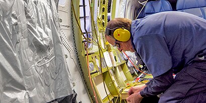engineer applying a product to an aircraft

