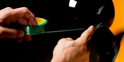 knifeless tape leaving a clean line on an auto wrap film install
